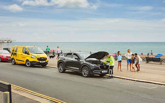 AA Patrol looking under hood of car