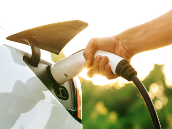 Close up of person charging their electric car