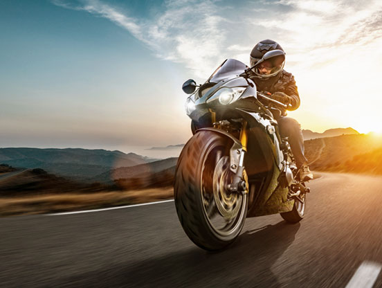 Motorcyclist driving down a remote county road